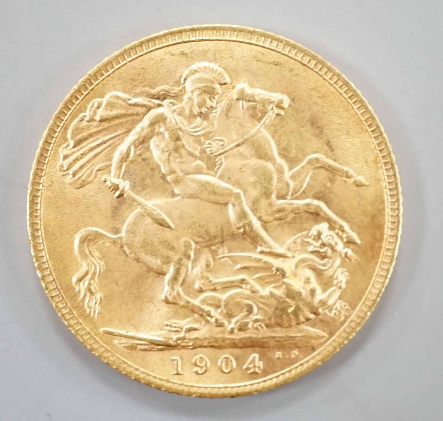 An Edward VII 1904 gold sovereign.